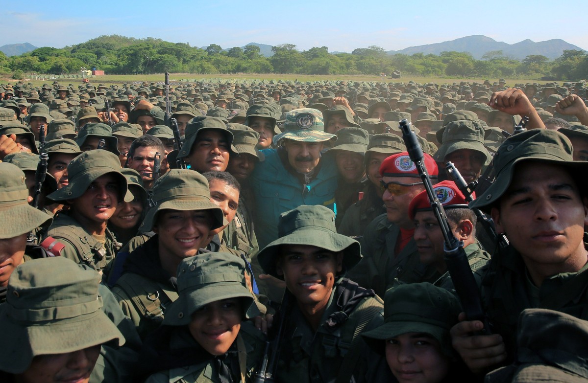 epa07681570 A handout photo made available by Miraflores Press Office shows Venezuelan President Nicolas Maduro (C) as he poses for a picture with members of the military in Cojedes State, Venezuela,  ...