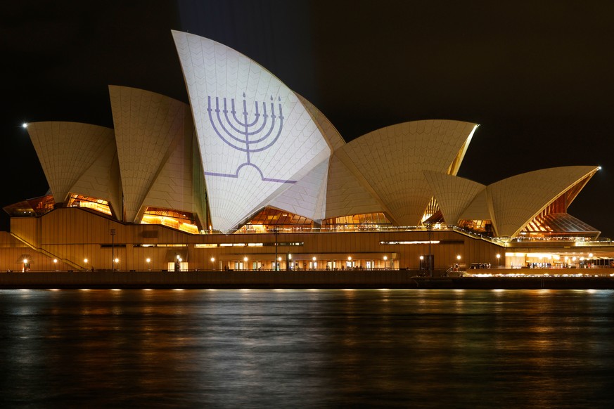 Sydney Opera House sails are illuminated with candles on a menorah, Monday, Dec 15, 2025, in tribute to Sunday's Bondi Beach shootings. (Jonathan Ng/Pool Photo via AP)
Australia Shooting