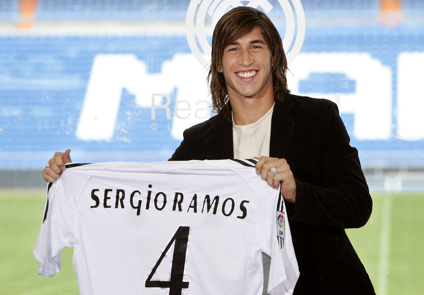 Real Madrid's new defender Sergio Ramos shows his shirt during the official presentation for the Spanish soccer club, Madrid, Thursday Sept. 8, 2005. Ramos, who has signed an eight-year contract, ...