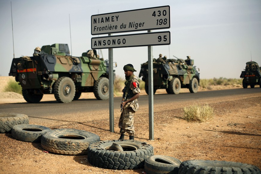 FILE - This Feb. 6, 2013, file photo shows French armoured vehicles heading towards the Niger border before making a left turn north in Gao, northern Mali. American and French forces have spent years  ...