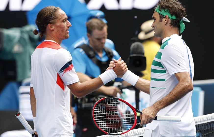 Roger Federer, right, of Switzerland is congratulated by Alexandr Dolgopolov of Ukraine after their second round match at the Australian Open tennis championships in Melbourne, Australia, Wednesday, J ...
