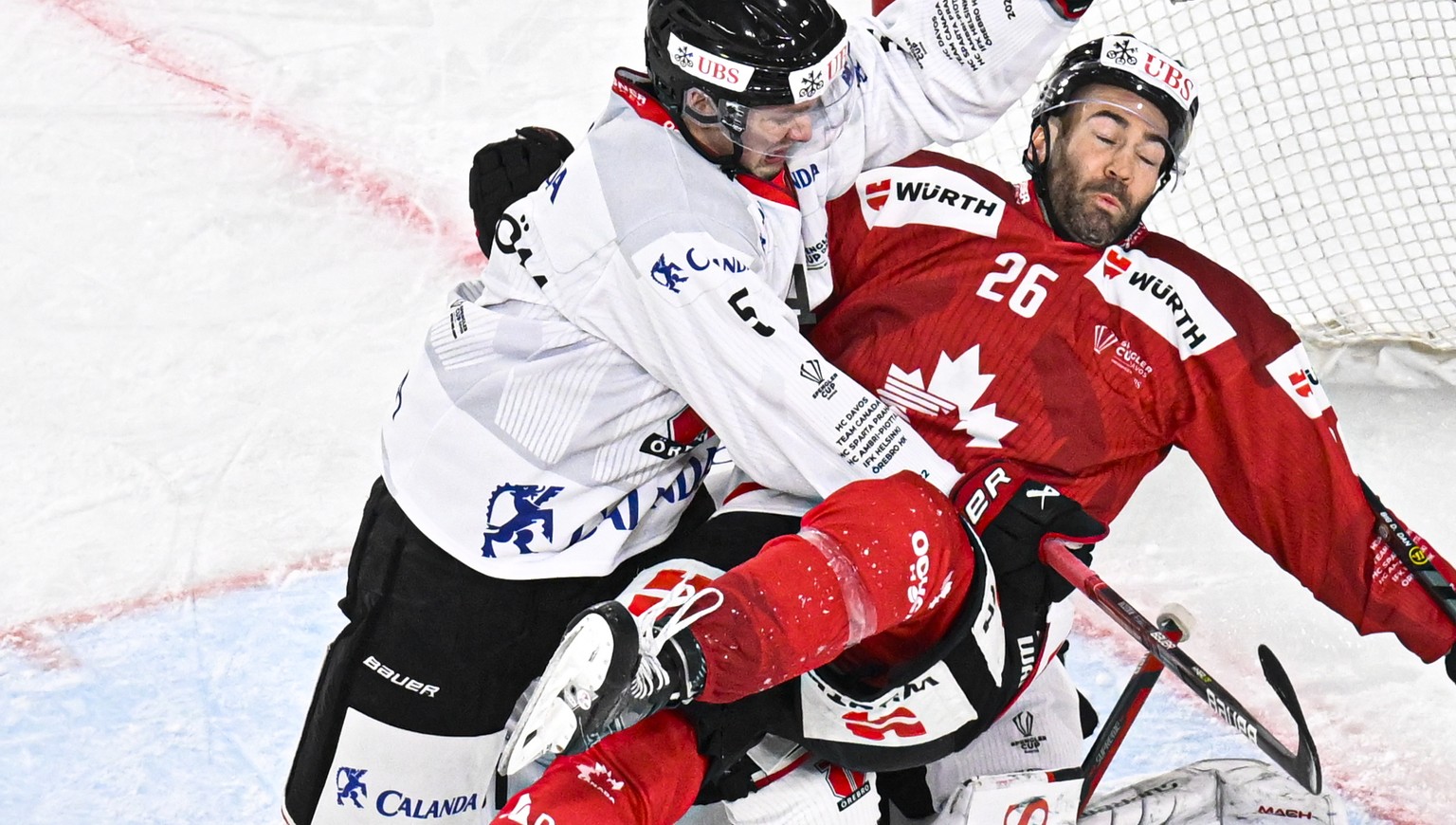epa10381583 Oerebro&#039;s Gustav Backstrom (L) in action against Canada&#039;s Daniel Winnik during the game between Oerebro HK and Team Canada at the 94th Spengler Cup ice hockey tournament in Davos ...