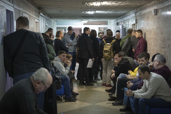 Recruits wait for their turn to pass medical examination in a city hospital in Kyiv, Ukraine, Thursday, Feb. 8, 2024. As the third year of war begins, the most sensitive and urgent challenge pressing  ...