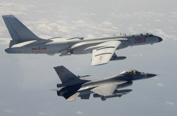 FILE - In this Feb. 10, 2020, file photo and released by the Republic of China (ROC) Ministry of National Defense, a Taiwanese Air Force F-16 in foreground flies on the flank of a Chinese People&#039; ...