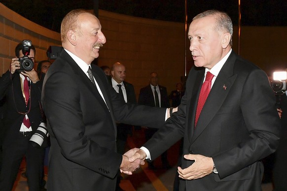 In this photo released by Azerbaijan&#039;s Presidential Press Office, Turkish President Recep Tayyip Erdogan, right, and Azerbaijan&#039;s President Ilham Aliyev greet each other during their meeting ...