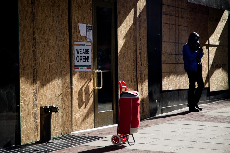 epa08797036 Plywood boards are installed in front of store windows as a precaution against potential damage from election related protests in Philadelphia, Pennsylvania, USA, 03 November 2020. America ...