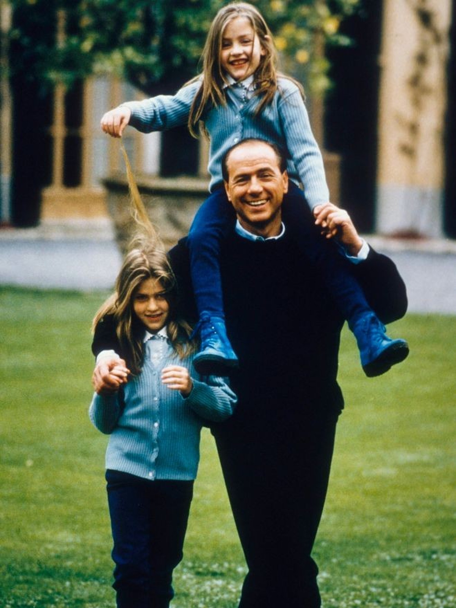 MILAN, ITALY - JANUARY 01: A young Silvio Berlusconi in the garden of his villa near Milan, with his daughters Barbara (L) and Eleonora whom he had from his second wife Veronica Lario in 1994 ca. in M ...