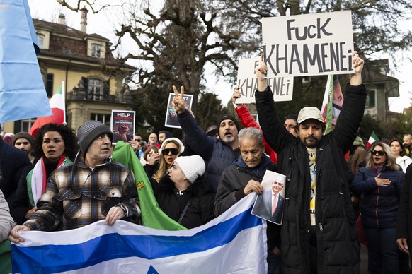 Protesters shout paroles and hold a "Fuck Khamenei" banner during a global protest against the Iranian regime in front of the Iranian embassy in Bern, Switzerland, Saturday, January 17, 2026 ...