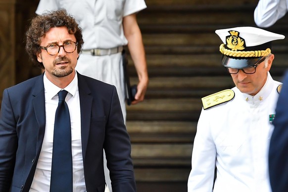 epa06956560 Italian Minister of Transportation and Infrastructures Danilo Toninelli (L) leaves the Prefecture of Genoa after a special Council of Ministers after the State funerals of victims of the M ...