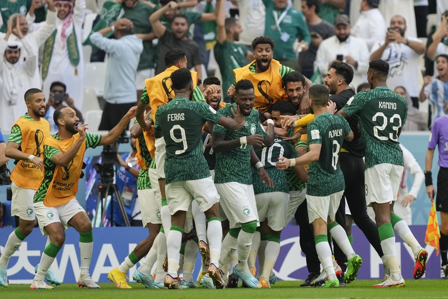 Saudi Arabia&#039;s Salem Al-Dawsari is congratulated after scoring his side&#039;s 2nd goal during the World Cup group C soccer match between Argentina and Saudi Arabia at the Lusail Stadium in Lusai ...