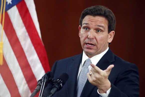 FILE - Florida Gov. Ron DeSantis answers questions from the media in the Florida Cabinet following his State of the State address during a joint session of the Senate and House of Representatives, Tue ...