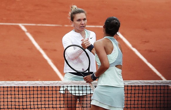 epa09977723 Qinwen Zheng (R) of China is congratulated by Simona Halep of Romania after winning their women&#039;s second round match during the French Open tennis tournament at Roland ?Garros in Pari ...