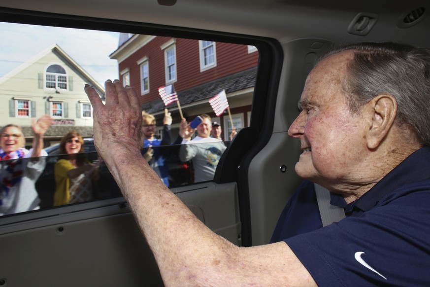 In this Sunday, May 20, 2018 photo provided by the office of former President George H.W. Bush, the former president waves to supporters as his motorcade arrives in Kennebunkport, Maine. A Bush spokes ...