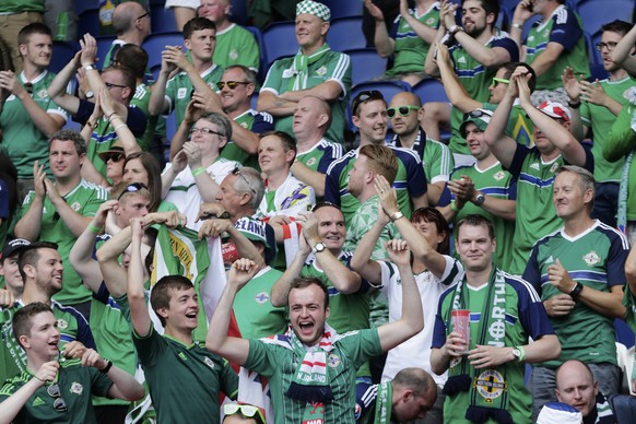 Fans of Northern Ireland cheer before the start of the Euro 2016 round of 16 soccer match between Wales and Northern Ireland, at the Parc des Princes stadium in Paris, Saturday, June 25, 2016. (AP Photo/Petr David Josek)
