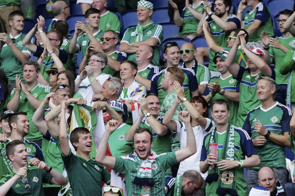 Fans of Northern Ireland cheer before the start of the Euro 2016 round of 16 soccer match between Wales and Northern Ireland, at the Parc des Princes stadium in Paris, Saturday, June 25, 2016. (AP Pho ...