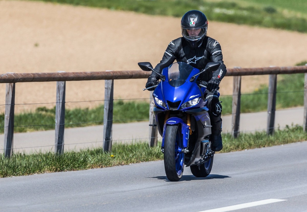 Oberglatt, Schweiz - 10. April 2021: Ein Motorradfahrer fährt mit seinem Motorrad, einer Yamaha YZF, auf einer Strassen ausserhalb einer Ortschaft.