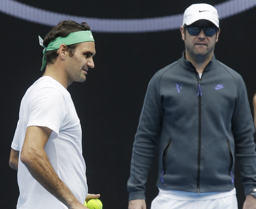 Switzerland's Roger Federer, left, talks with his coaches Ivan Ljubicic right, and Severin Luthi during a practice session ahead of the Australian Open tennis championships in Melbourne, Australia, Fr ...