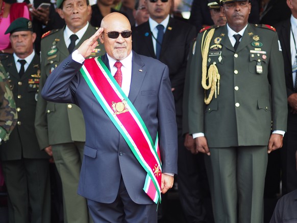 FILE - In this Aug. 12, 2015, file photo, Suriname President Desire Delano Bouterse salutes during a military parade, after being sworn in for his second term, in Paramaribo, Suriname. A two-time coup ...