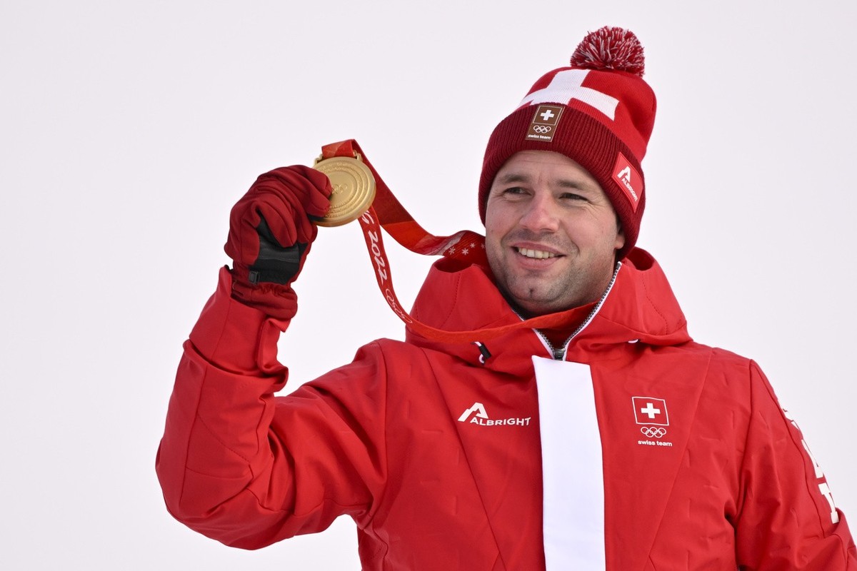 Gold medalist Beat Feuz of Switzerland celebrates during the victory ceremony of the men's Alpine Skiing downhill race at the 2022 Olympic Winter Games in Yanqing, China, on Monday, February 7, 2 ...
