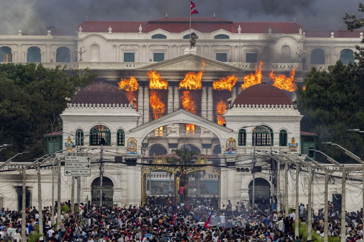 KEYPIX - epa12364471 Fire and smoke rise from the Singha Durbar palace, which houses government and parliament buildings, after protesters stormed the premises during violent demonstrations in Kathman ...