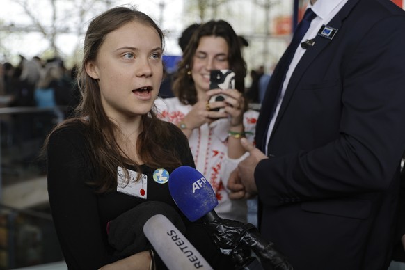 epa11266978 Swedish climate activist Greta Thunberg (L) speaks to the press in front of the court, during the judgement in a case against different European countries accused of climate inaction, at t ...