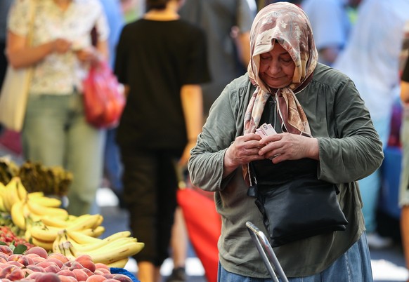 epa10127276 A woman shops at a local market in Istanbul, Turkey, 18 August 2022. The Turkish Central Bank cut a 100-basis points interest rate amid an inflation of nearly 80 per cent. Thus, the new po ...