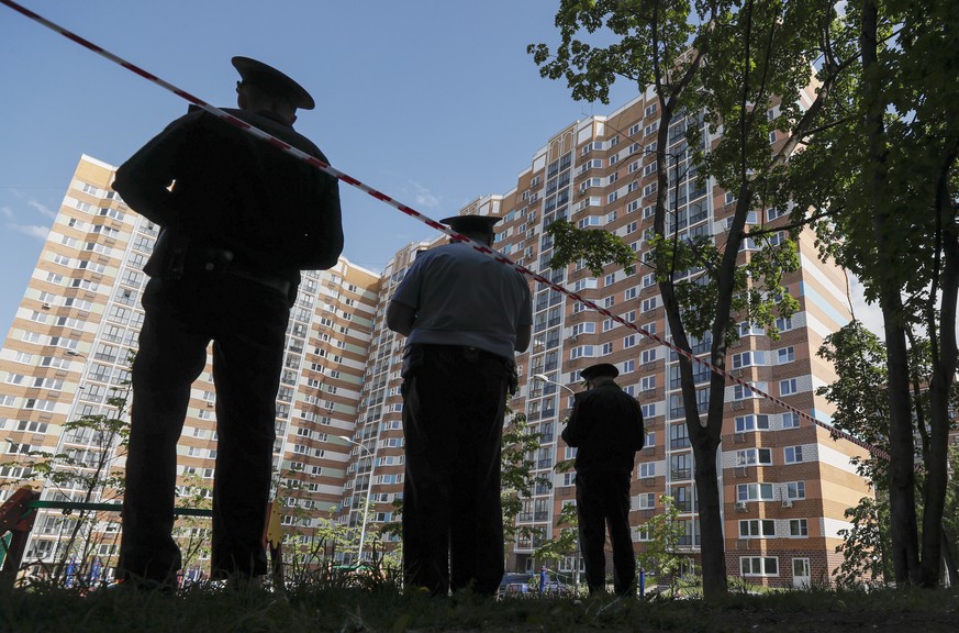 epa10662745 Russian policemen stand guard near a damaged residential building following a reported drone attack in Moscow, Russia, 30 May 2023. An unmanned aerial vehicle (UAV) attack caused &#039;min ...