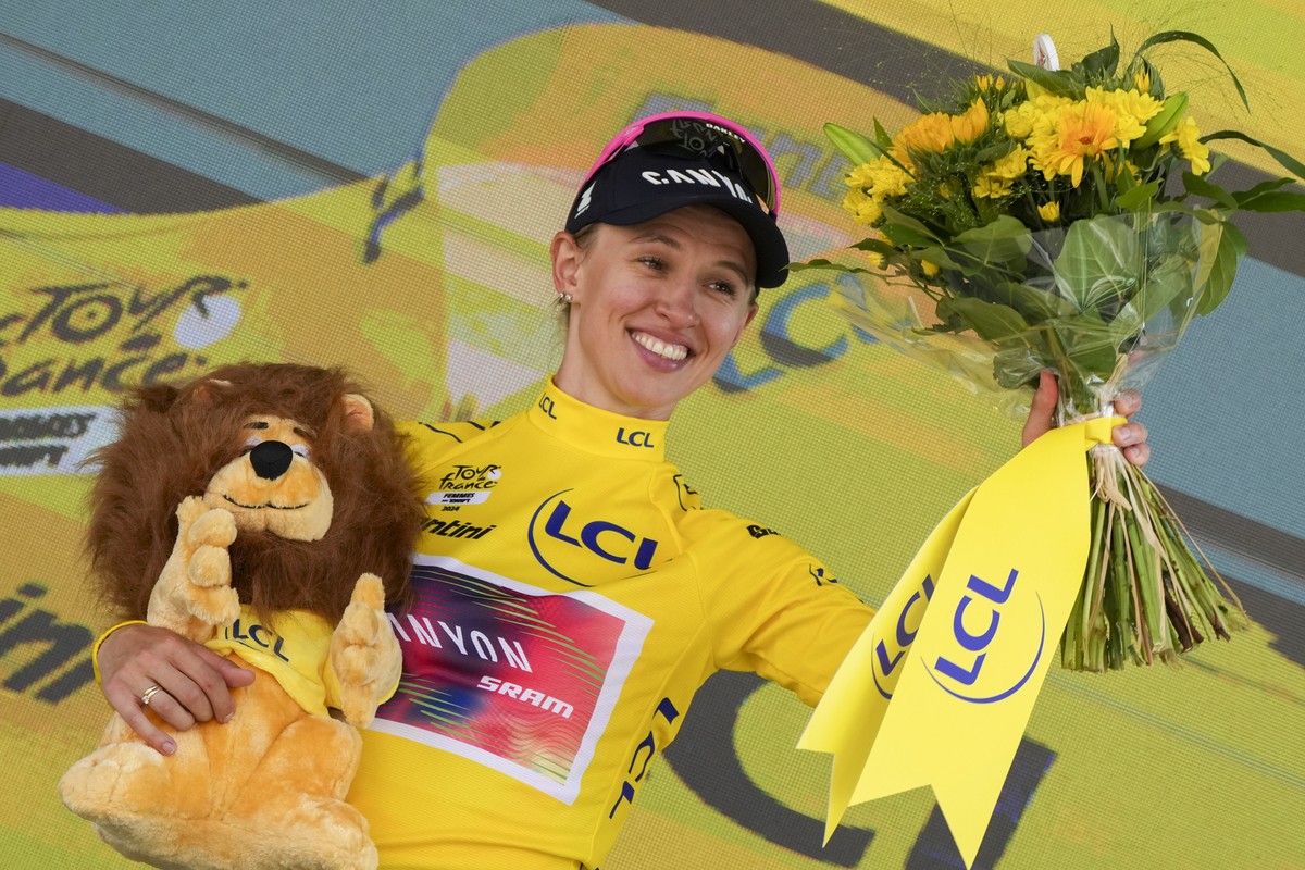 Katarzyna Niewiadoma of Poland, wearing the overall leader's yellow jersey, celebrates on the podium after the sixth stage of the Tour de France Women cycling race with start in Remiremont and fi ...