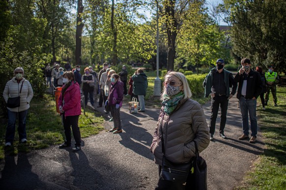 epa08379355 People stand in line for testing for Coronavirus antibodies in Prague, Czech Republic, 23 April 2020. Czech Republic starts voluntary testing for coronavirus antibodies in a few cities acr ...