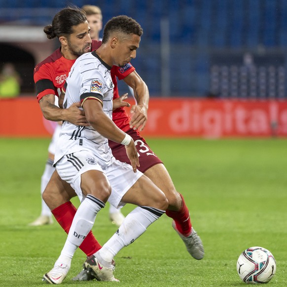 Switzerland&#039;s Ricardo Rodriguez, left, fights for the ball against Germany&#039;s Thilo Kehrer, right, during the UEFA Nations League group 4 soccer match between Switzerland and Germany at the S ...