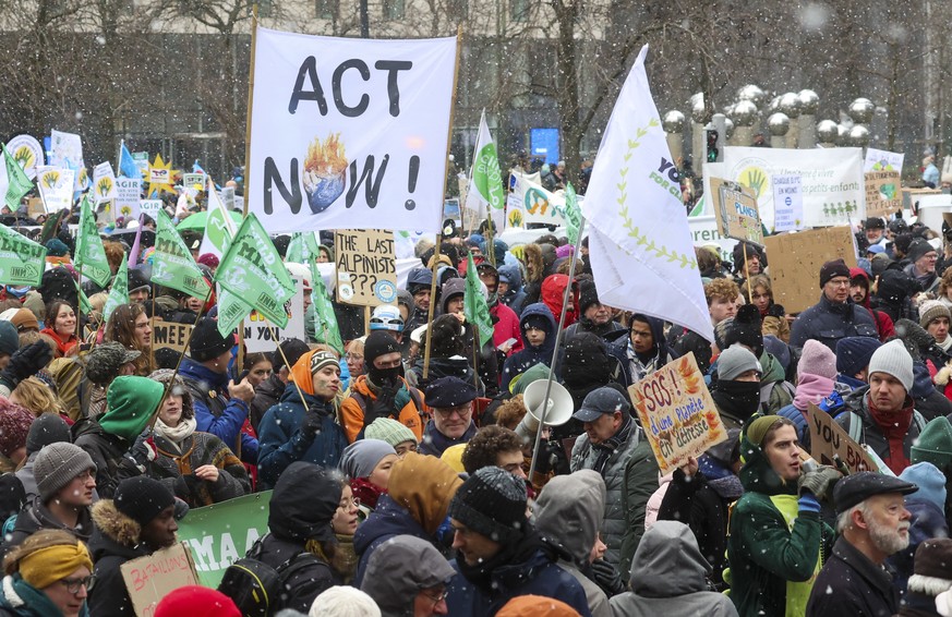 epa11009017 People hold placards during the annual Big Climate March 2023, in Brussels, Belgium, 03 December 2023. The protest, coinciding with the 2023 United Nations Climate Change Conference (COP28 ...