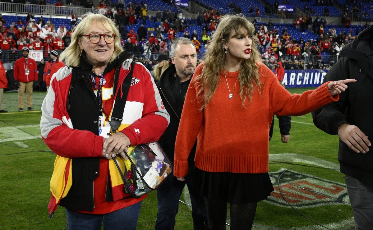 Taylor Swift, right, walks with Donna Kelce on the field after the AFC Championship NFL football game between the Baltimore Ravens and the Kansas City Chiefs, Sunday, Jan. 28, 2024, in Baltimore. (AP  ...