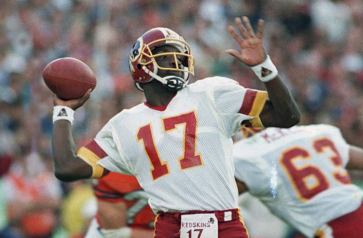 FILE - In this Jan. 31, 1988, file photo, Washington Redskins quarterback Doug Williams prepares to let go of a pass during first quarter of Super Bowl XXII against the Denver Broncos in San Diego. Br ...