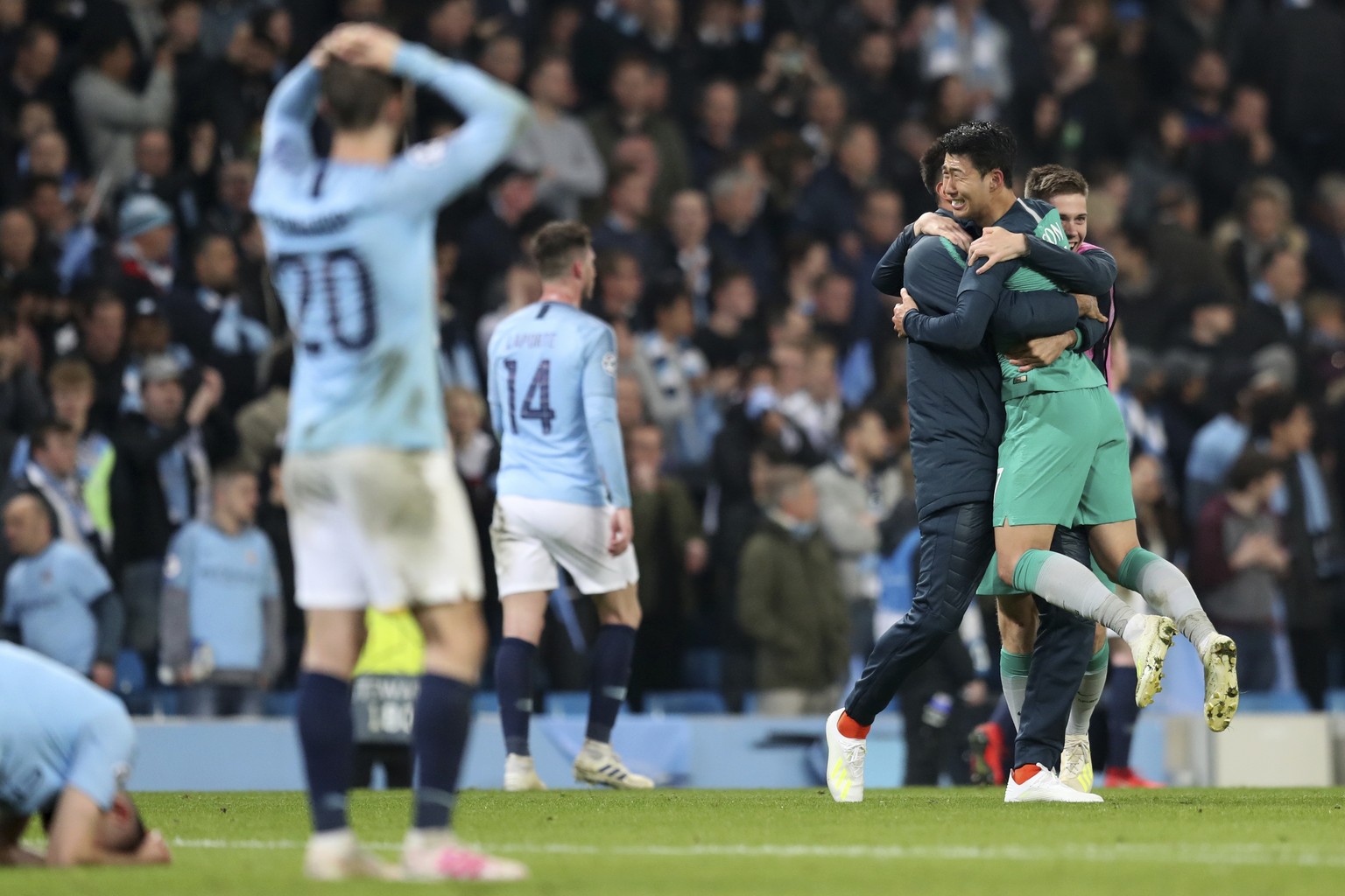 Tottenham Hotspur forward Son Heung-Min, right, celebrates as Manchester City players react after the Champions League quarterfinal, second leg, soccer match between Manchester City and Tottenham Hots ...