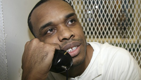 In this June 13, 2018, photo, death-row inmate Christopher Young holds a phone to his ear during an interview outside death row at the Texas Department of Criminal Justice Polunsky Unit near Livingsto ...