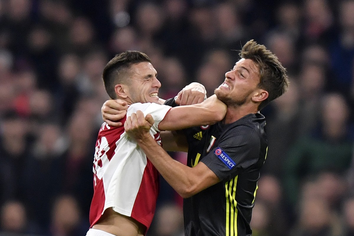Ajax's Dusan Tadic, left, fights for the ball with Juventus' Daniele Rugani during the Champions League quarterfinal, first leg, soccer match between Ajax and Juventus at the Johan Cruyff Ar ...