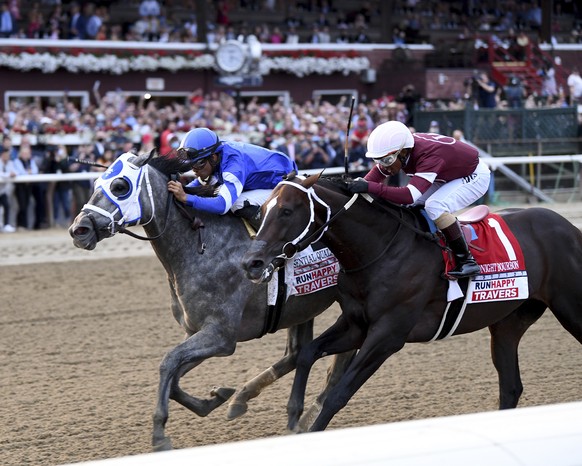 In a photo provided by the New York Racing Association, Essential Quality, left, with jockey Luis Saez, holds off Midnight Bourbon, with Ricardo Santana Jr., to win the Travers Stakes horse race Satur ...
