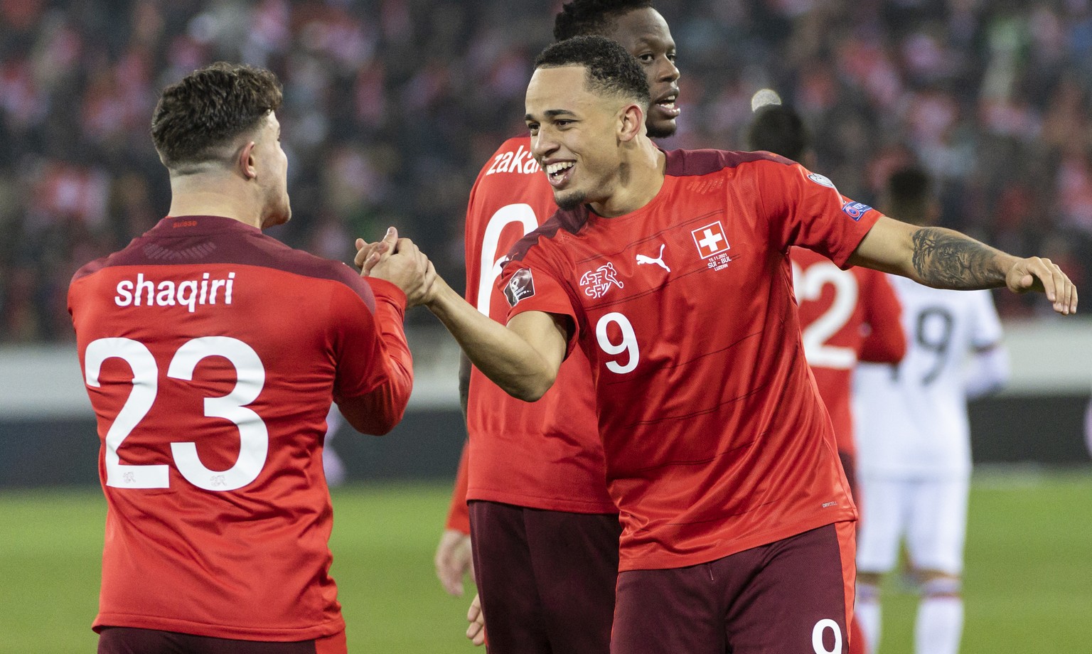 Switzerland&#039;s forward Noah Okafor, center, celebrates after scoring to 1:0 with Xherdan Shaqiri, left, and Denis Zakaria, during the 2022 FIFA World Cup European Qualifying Group C match between  ...