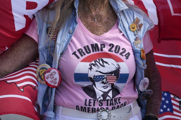 &quot;Maga&quot; Mary Kelley of Lake Worth, Fla., wears a Trump T-shirt and buttons as she shows support for former President Donald Trump one day after he was indicted by a Manhattan grand jury, Frid ...