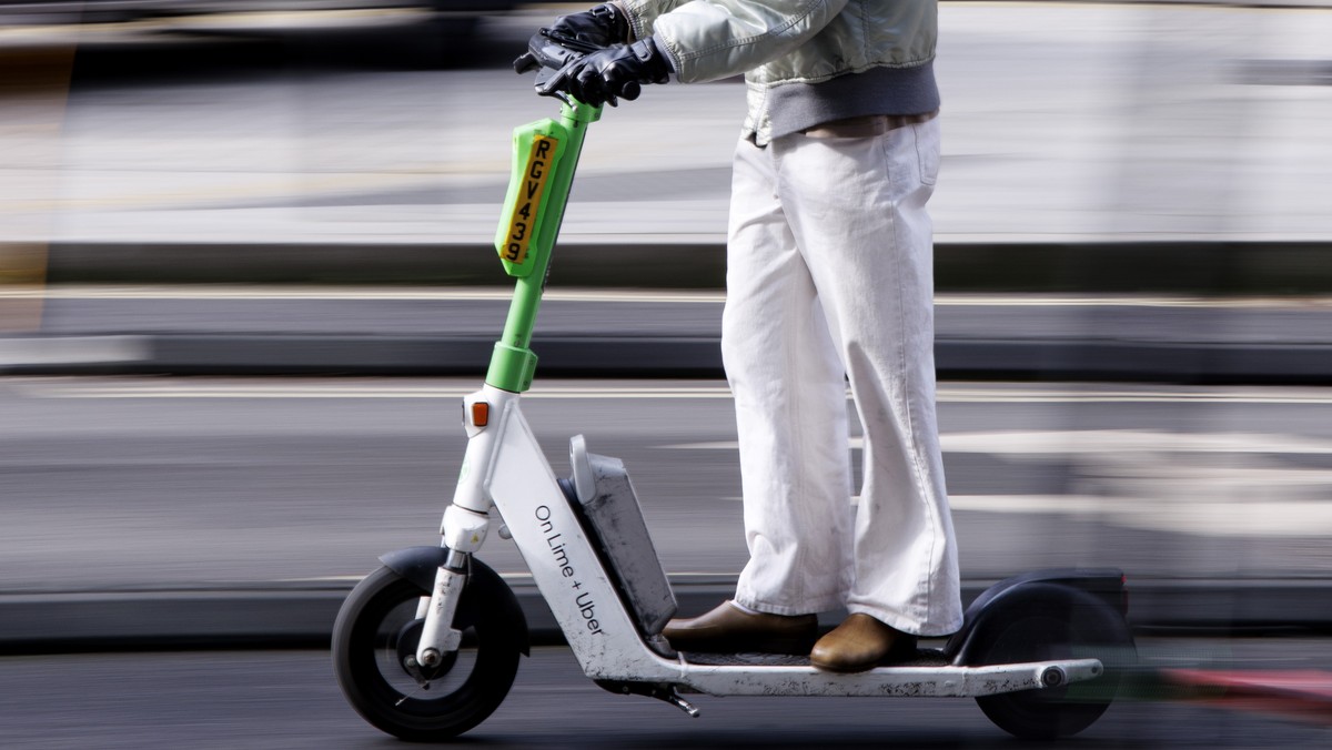 epa11923954 A person rides a Lime rental e-scooter in central London, Britain, 25 February 2025. Westminster council will convert around 200 car parking spaces in central London into parking bays for  ...