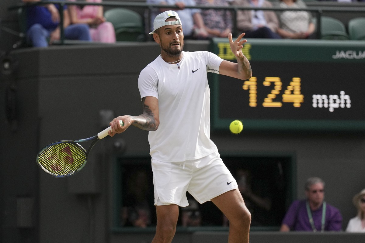 Australia's Nick Kyrgios returns the ball to Chile's Cristian Garin during a men's singles quarterfinal match on day ten of the Wimbledon tennis championships in London, Wednesday, July ...