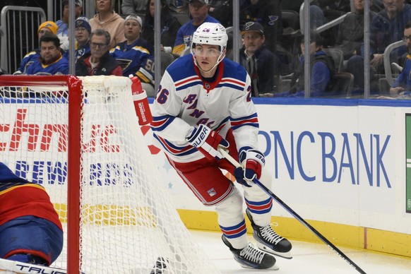 New York Rangers left wing Jimmy Vesey, right, controls the puck during the first period of an NHL hockey game against the St. Louis Blues, Sunday, Dec. 15, 2024, in St. Louis. (AP Photo/Jeff Le)