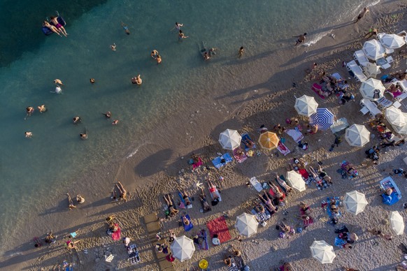 Holidaymakers enjoy the weather on a beach, in Dubrovnik, Croatia, Friday, Aug. 13, 2021. Summer tourism has exceeded even the most optimistic expectations in Croatia this year. Beaches along the coun ...