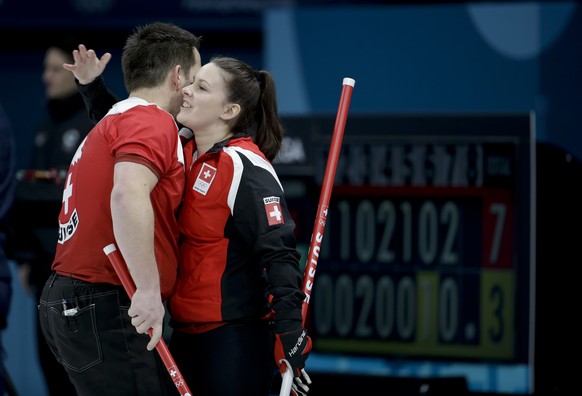 Switzerland Jenny Perret, right, and teammate Martin Rios, celebrate winning a mixed doubles curling match against Olympic Athletes from Russia Anastasia Bryzgalova and Aleksandr Krushelnitckii at the ...