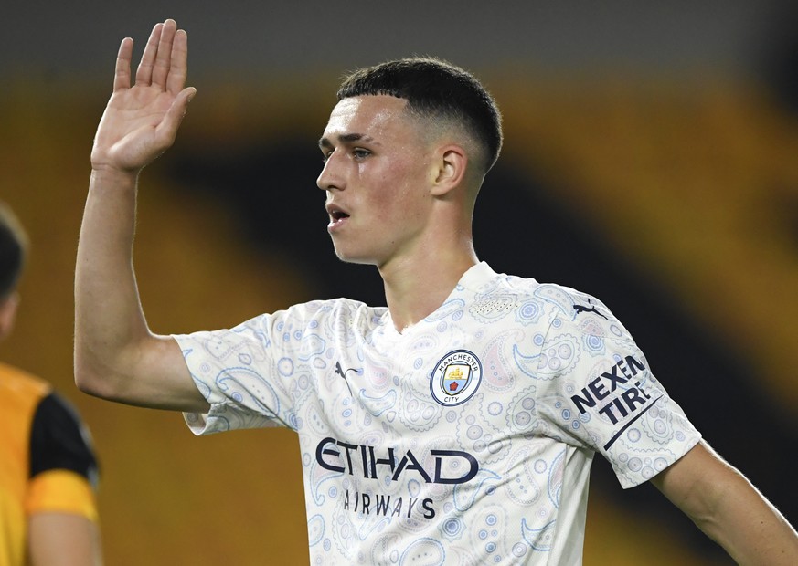 Manchester City&#039;s Phil Foden reacts after scoring his team&#039;s second goal during the English Premier League soccer match between Wolverhampton Wanderers and Manchester City at Molineux Stadiu ...