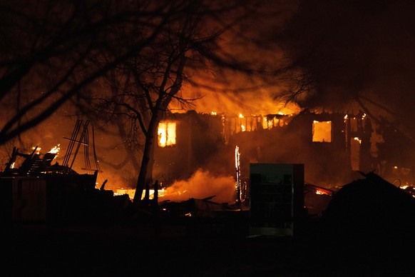 The Marshall Fire engulfs a home in Louisville, Colo., Thursday, Dec. 30, 2021, as crews worked through the night battling the blaze that had destroyed more than 500 home in Boulder County. (Christian ...