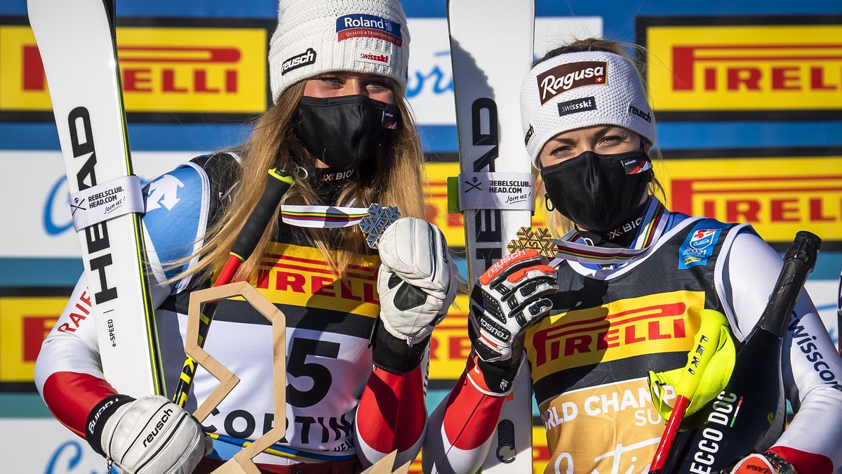 Corinne Suter of Switzerland and Lara Gut-Behrami of Switzerland celebrate with the Silver and Gold medals for Super-g race during the medals ceremony after the women's Super-G race at the 2021 F ...