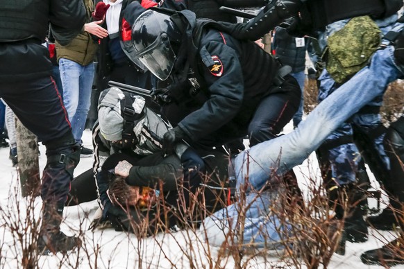 FILE In this Jan. 23, 2021, file photo, riot police detain a demonstrator with a bloody face during a protest against the jailing of opposition leader Alexei Navalny in Pushkin square in Moscow, Russi ...