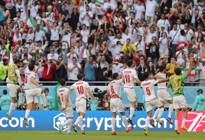 epa10327217 Players of Iran celebrate winning the 2022 FIFA World Cup group B soccer match between Wales and Iran at Ahmad bin Ali Stadium in Doha, Qatar, November 25, 2022. EPA/Friedemann Vogel