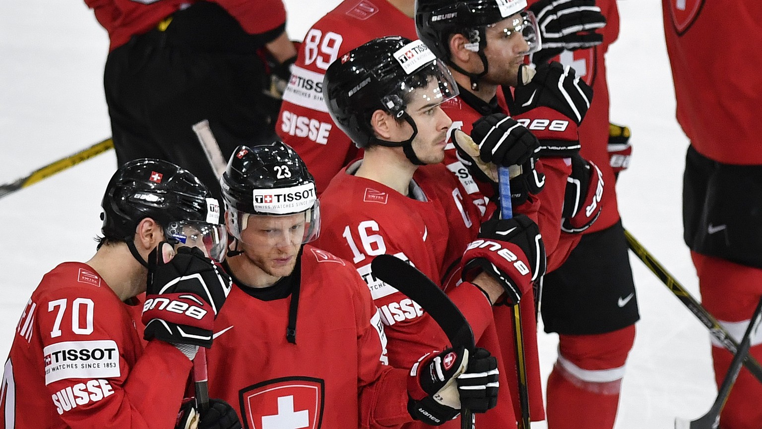 Switzerland&#039;s Denis Hollenstein, Simon Bodenmann and Rafael Diaz, from left, react after their Ice Hockey World Championship group B preliminary round match between Switzerland and France in Pari ...